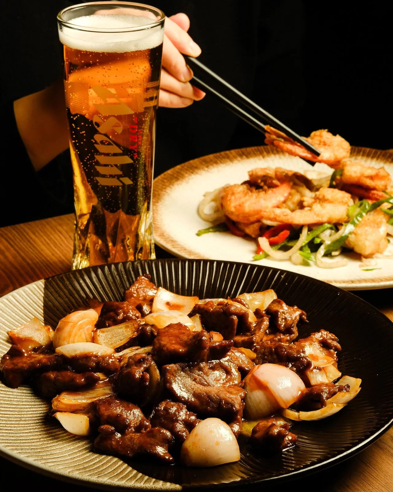 Beer next to Asian dishes