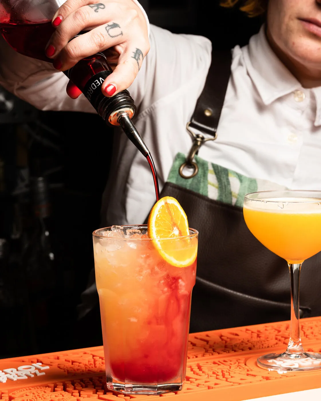Bartender pouring cocktails at the bar
